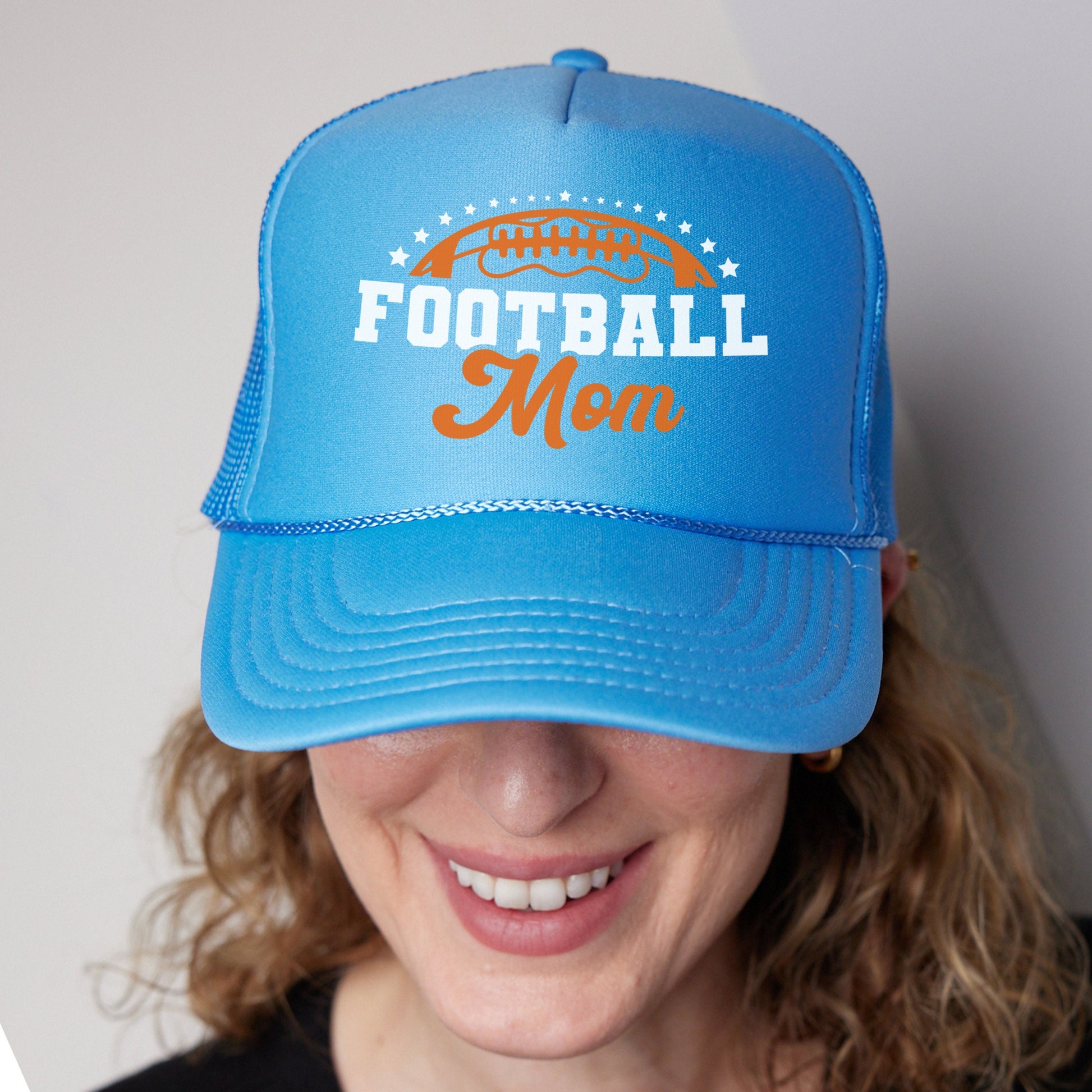 a woman wearing a blue football mom hat