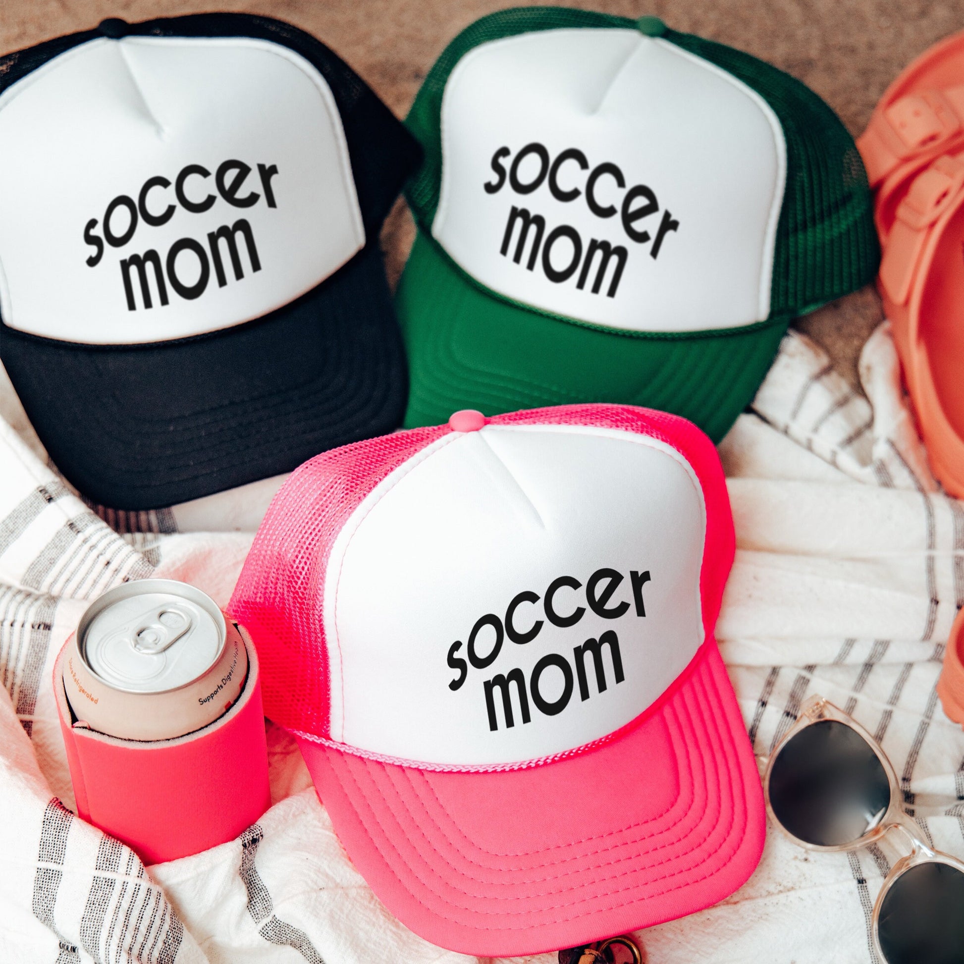 three soccer mom hats sitting on top of a blanket