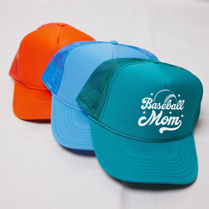 three different colored hats sitting on top of a white surface