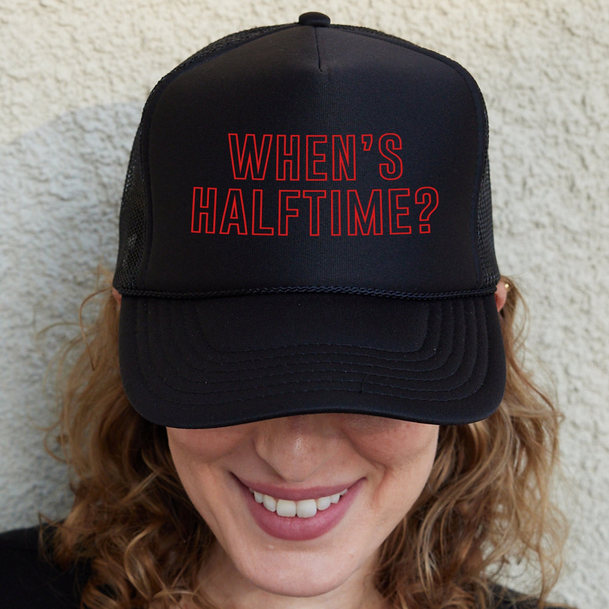 a woman wearing a hat with the words when&#39;s half time?