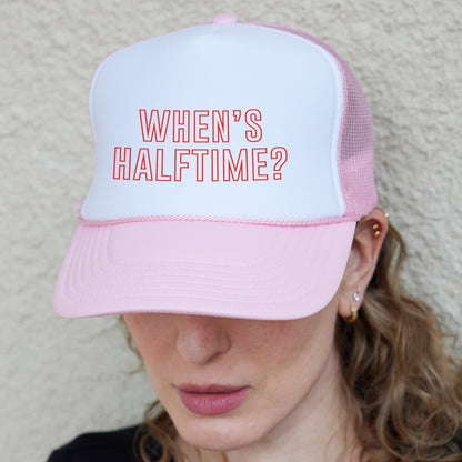 a woman wearing a pink and white hat with the words when&#39;s half time