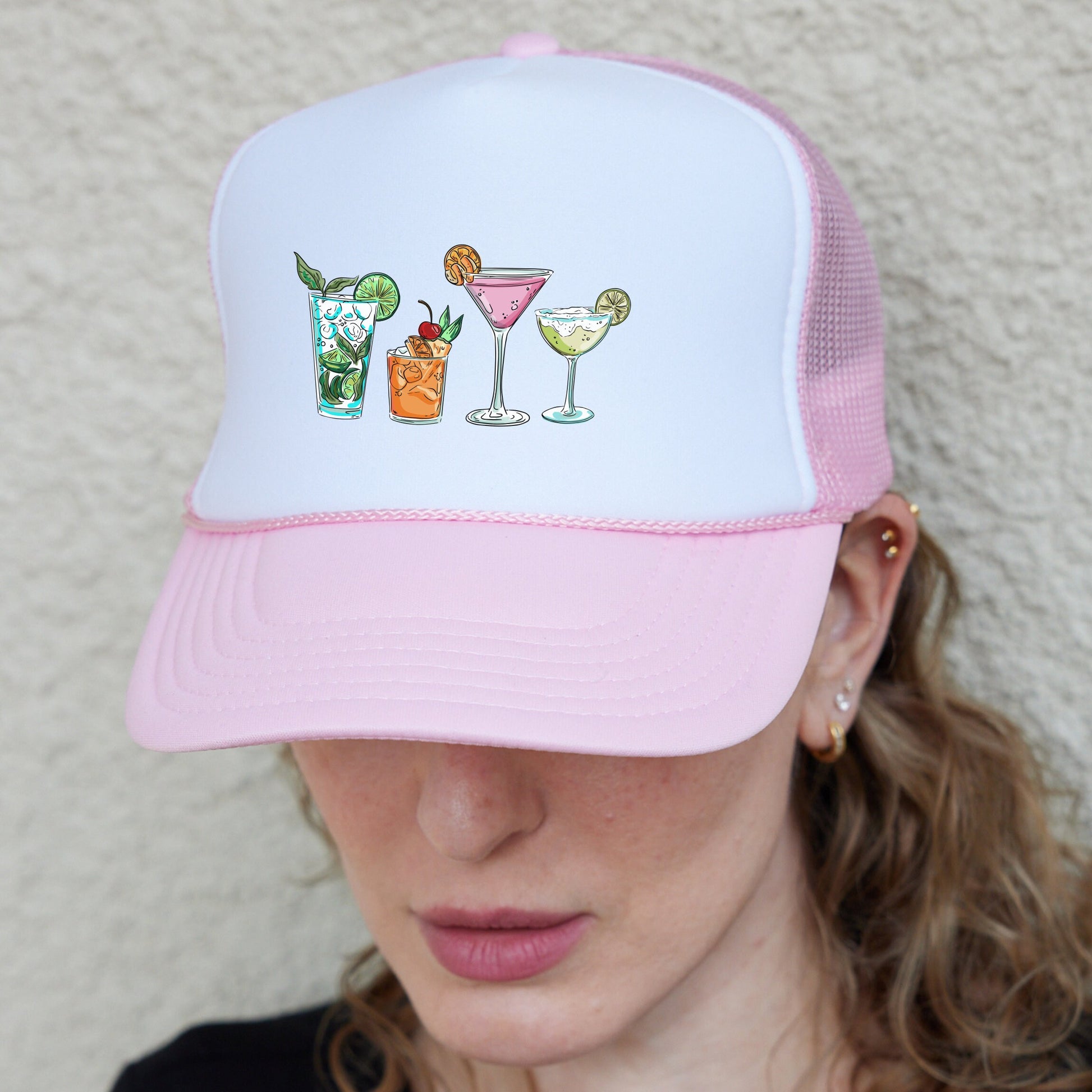 a woman wearing a pink and white trucker hat