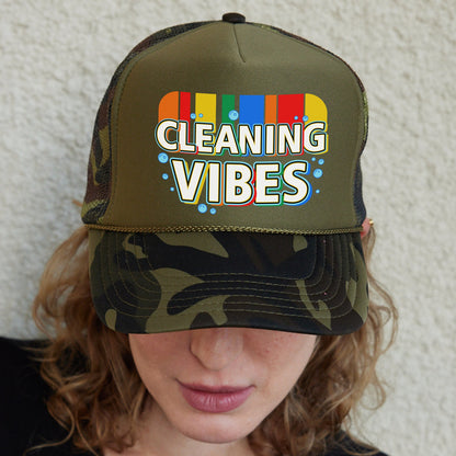a woman wearing a camo trucker hat with cleaning vibes on it