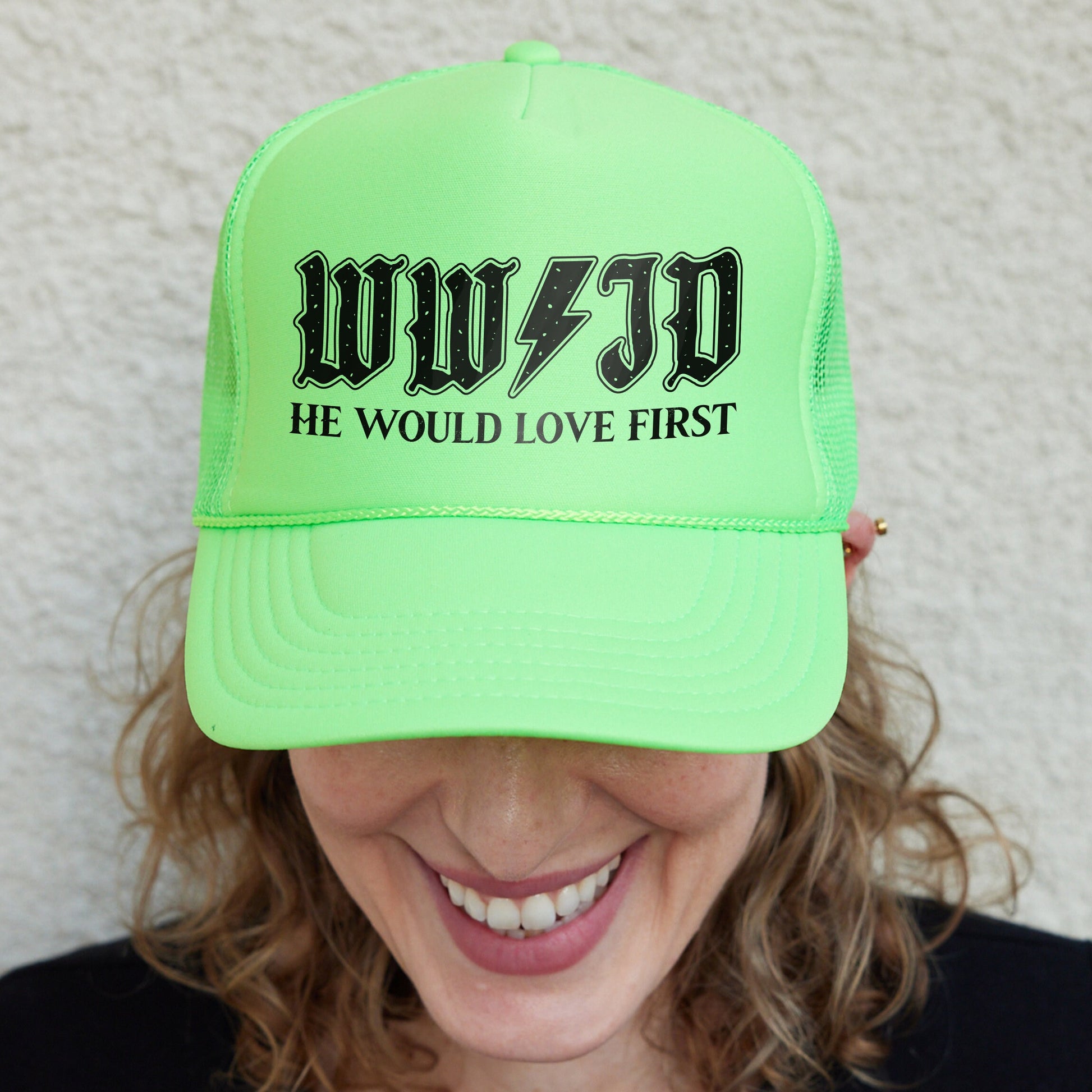 a woman wearing a neon green hat with the words wuf - d he would