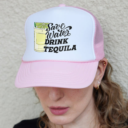 a woman wearing a pink and white trucker hat