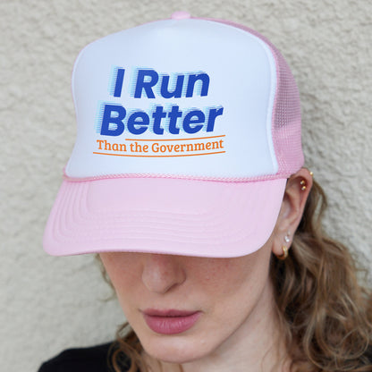 a woman wearing a pink and white hat with i run better than the government