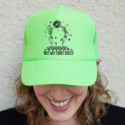 a smiling woman wearing a neon green hat