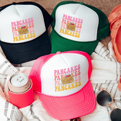 three hats and sunglasses are laying on a blanket