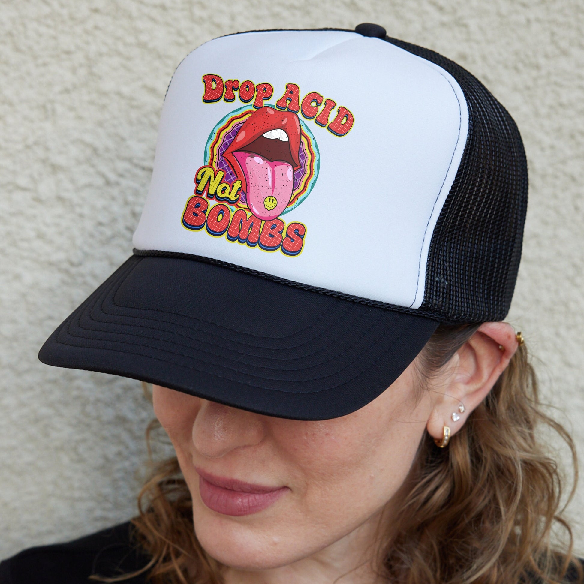 a woman wearing a black and white trucker hat