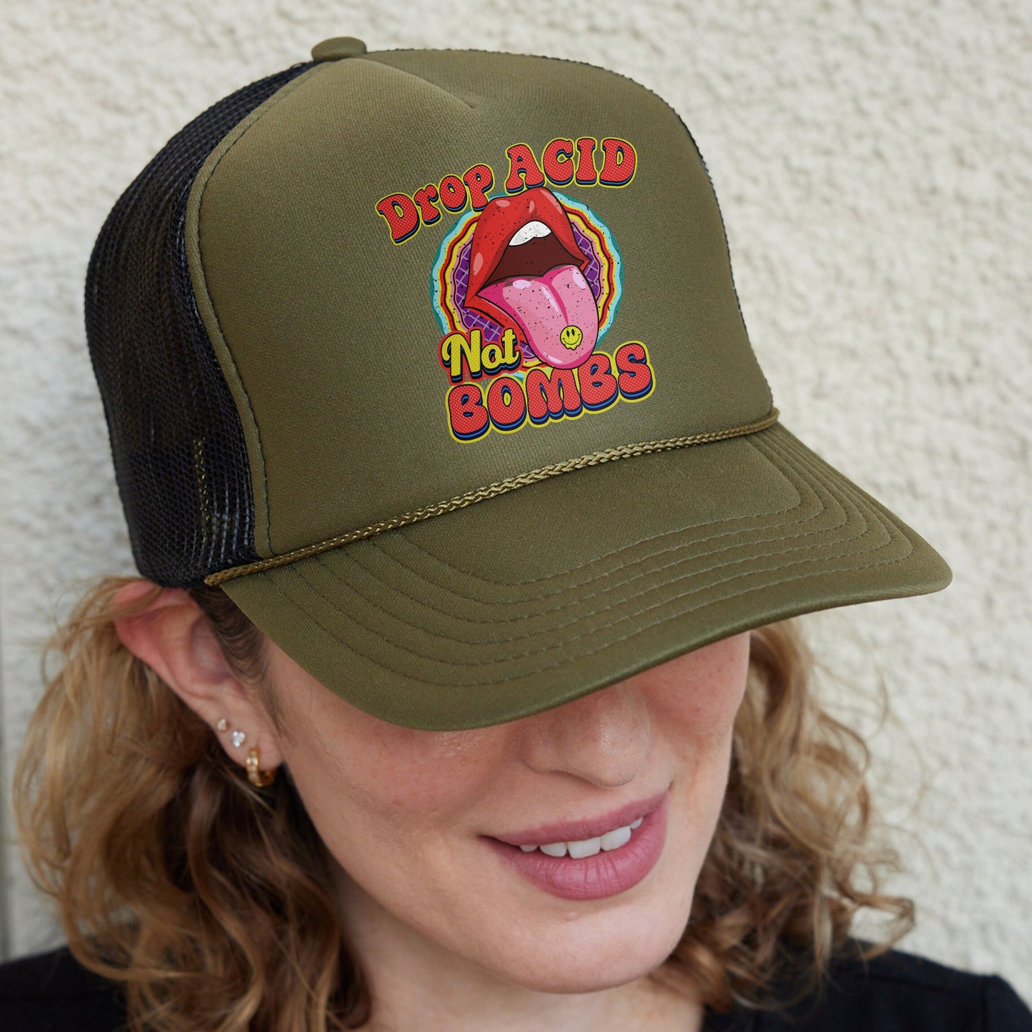 a woman wearing a trucker hat with a tongue on it