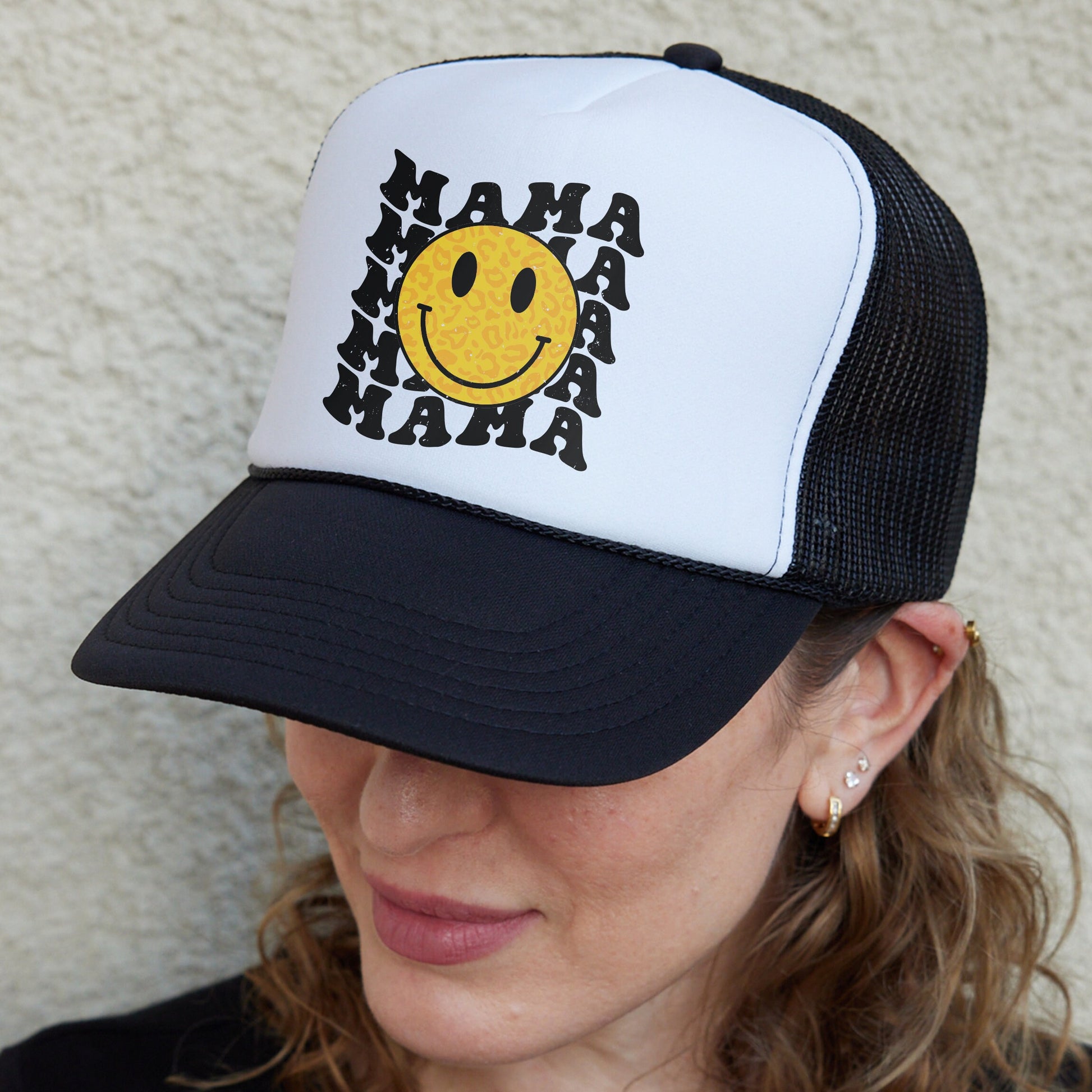 a woman wearing a hat with a smiley face on it