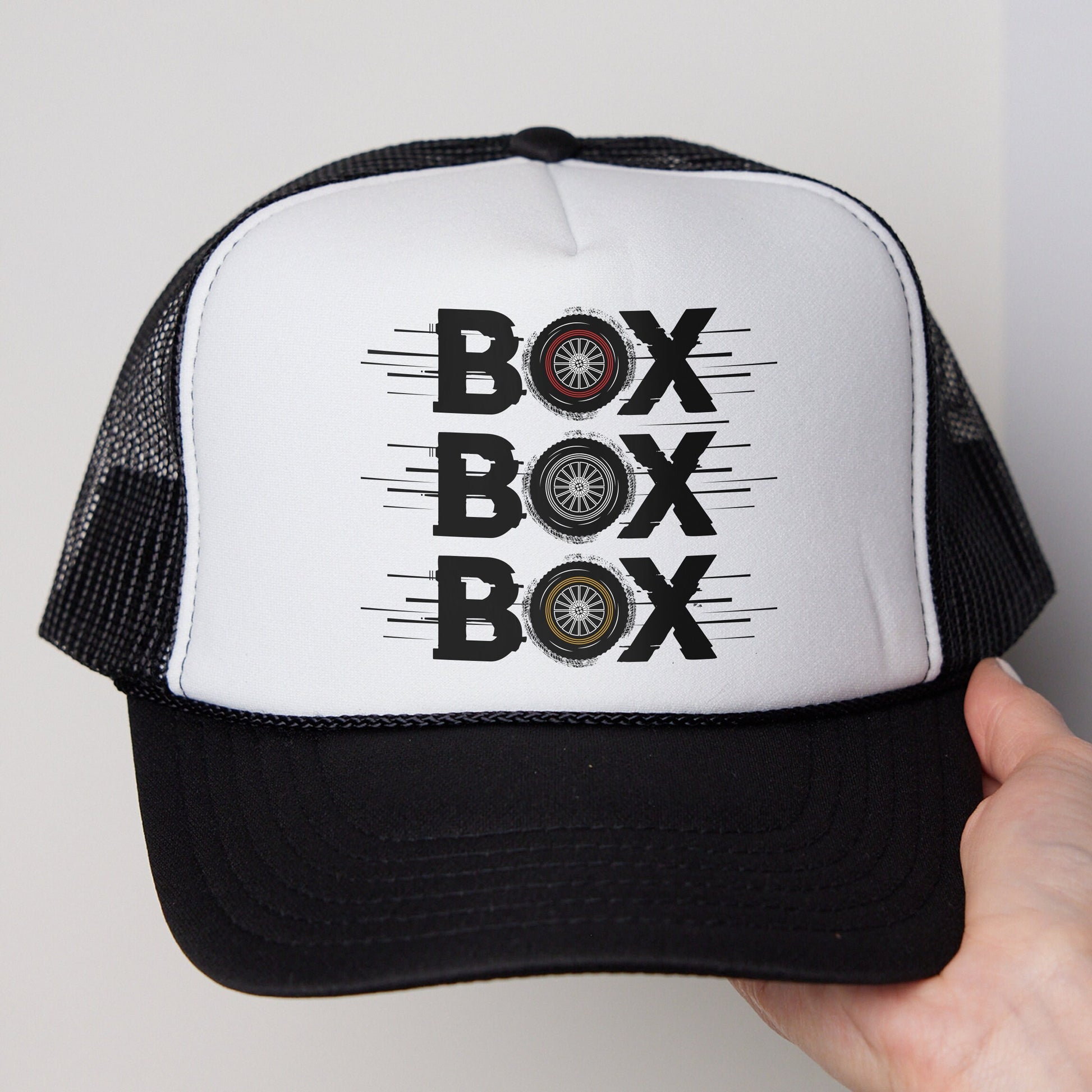 a white and black trucker hat with the words box box on it
