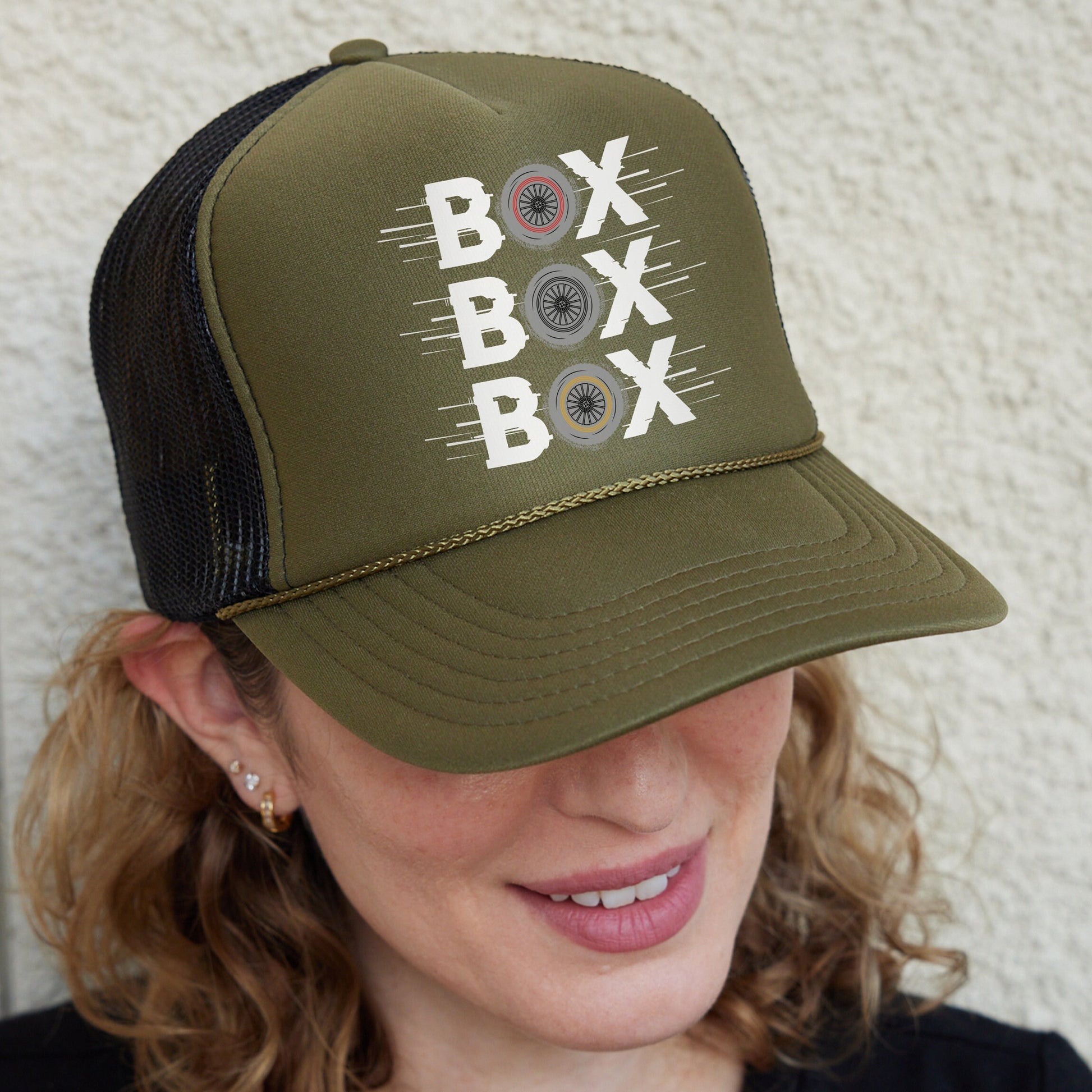 a woman wearing a green hat with buttons on it