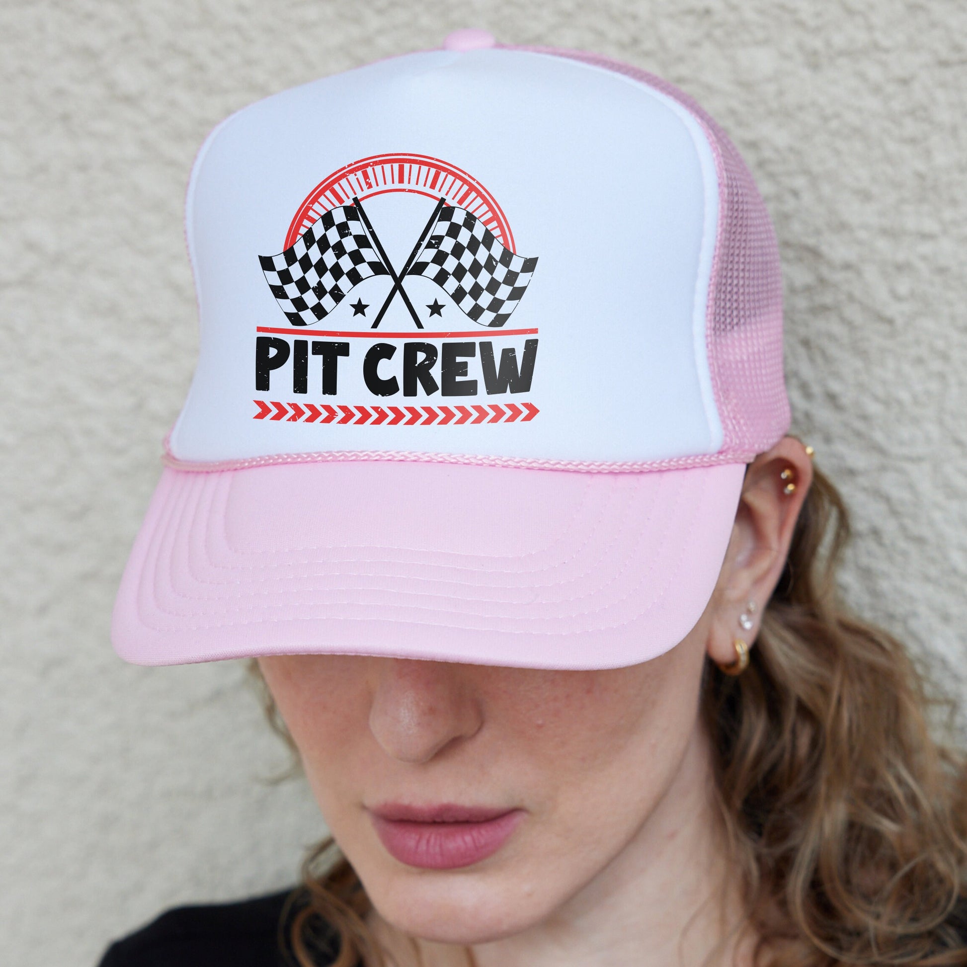 a woman wearing a pink and white hat
