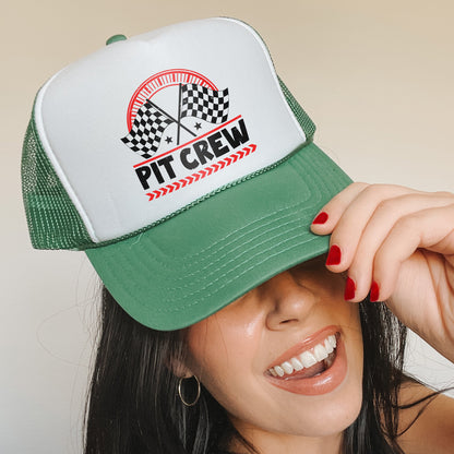 a woman wearing a green and white trucker hat