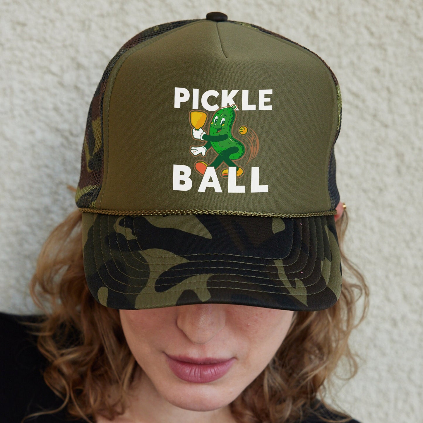 a woman wearing a pickle ball hat