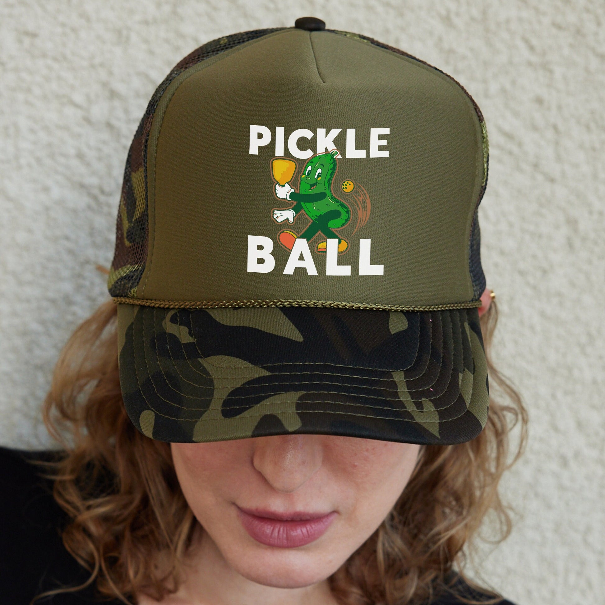 a woman wearing a pickle ball hat