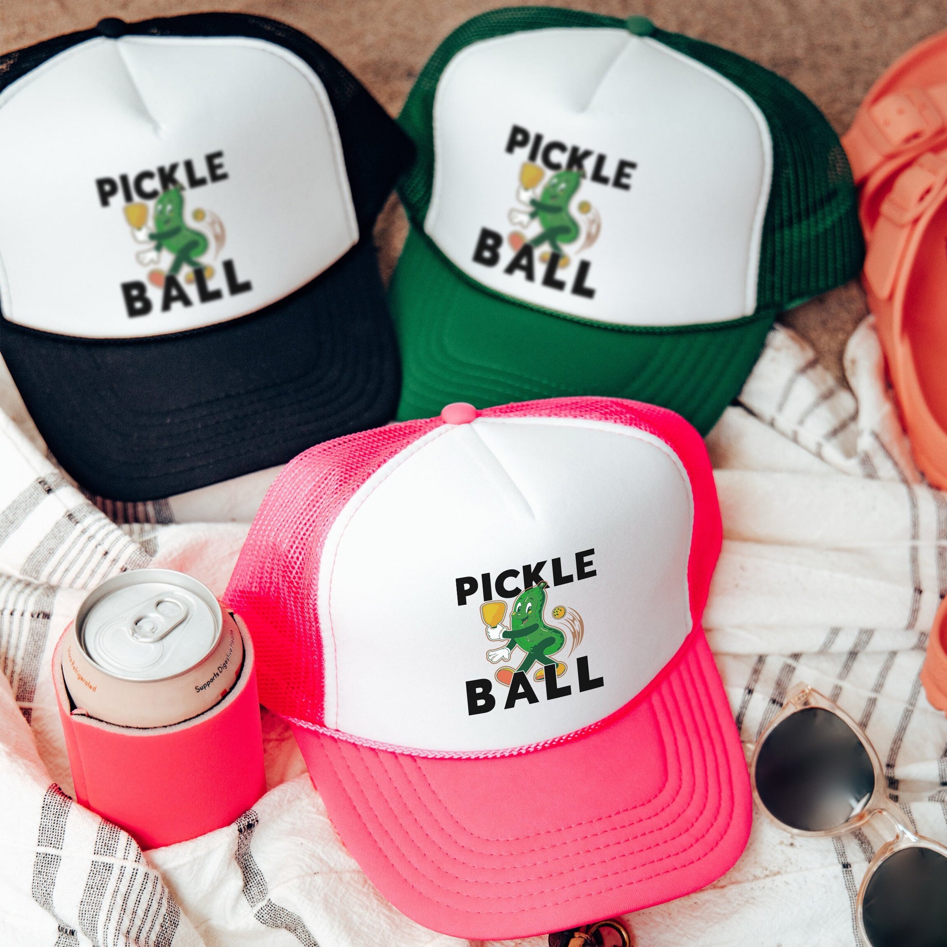 three pickle ball hats sitting on top of a towel