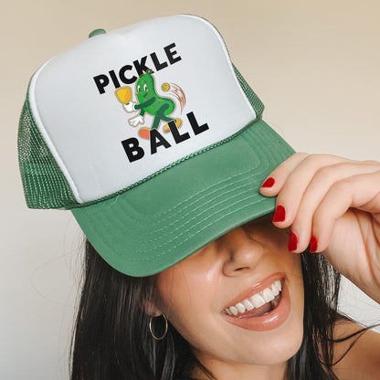 a woman wearing a green and white pickle ball hat
