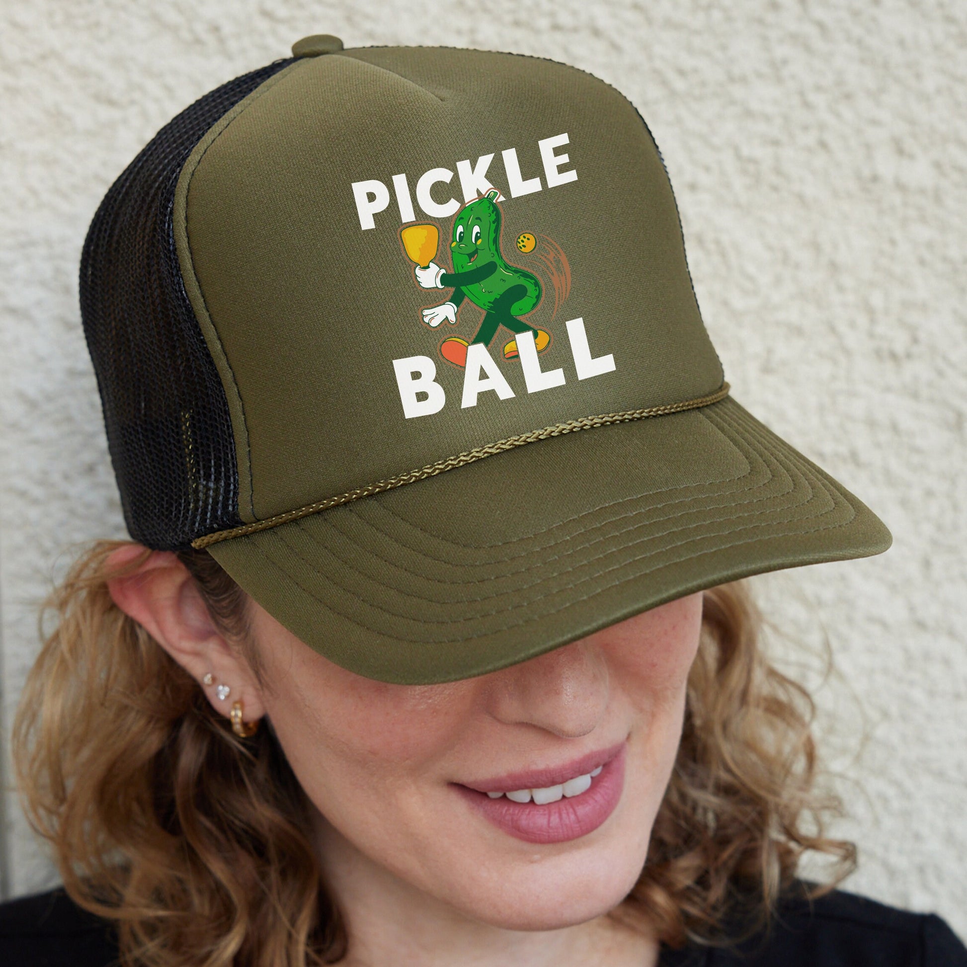 a woman wearing a pickle and ball hat
