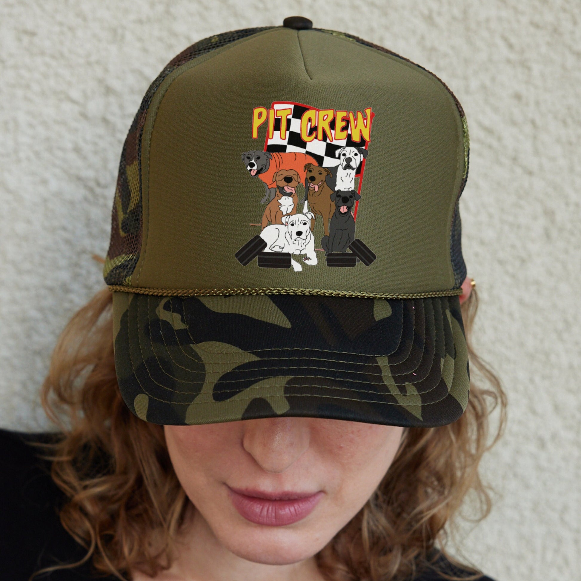 a woman wearing a hat with a picture of dogs on it