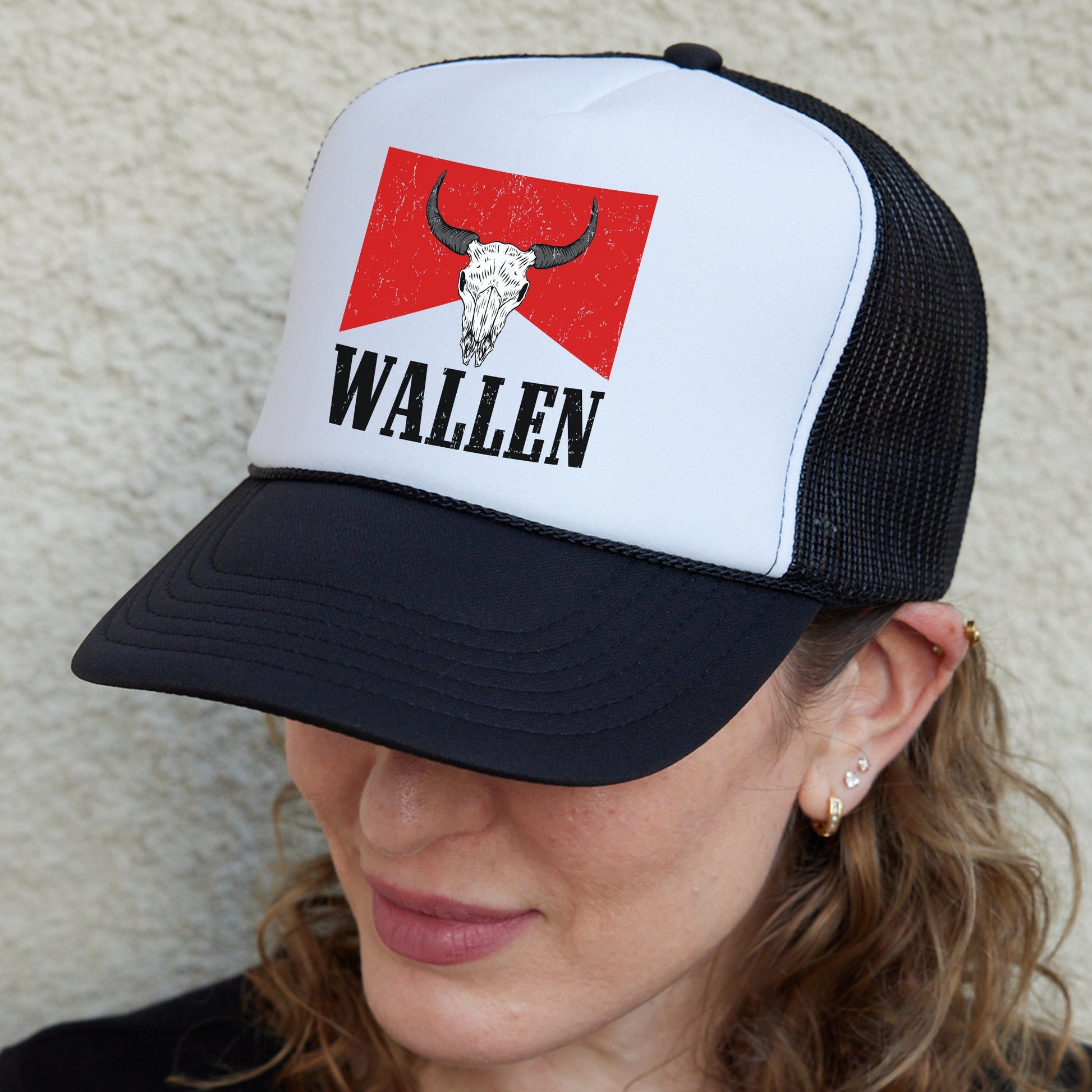 a woman wearing a hat with a bull&#39;s head on it