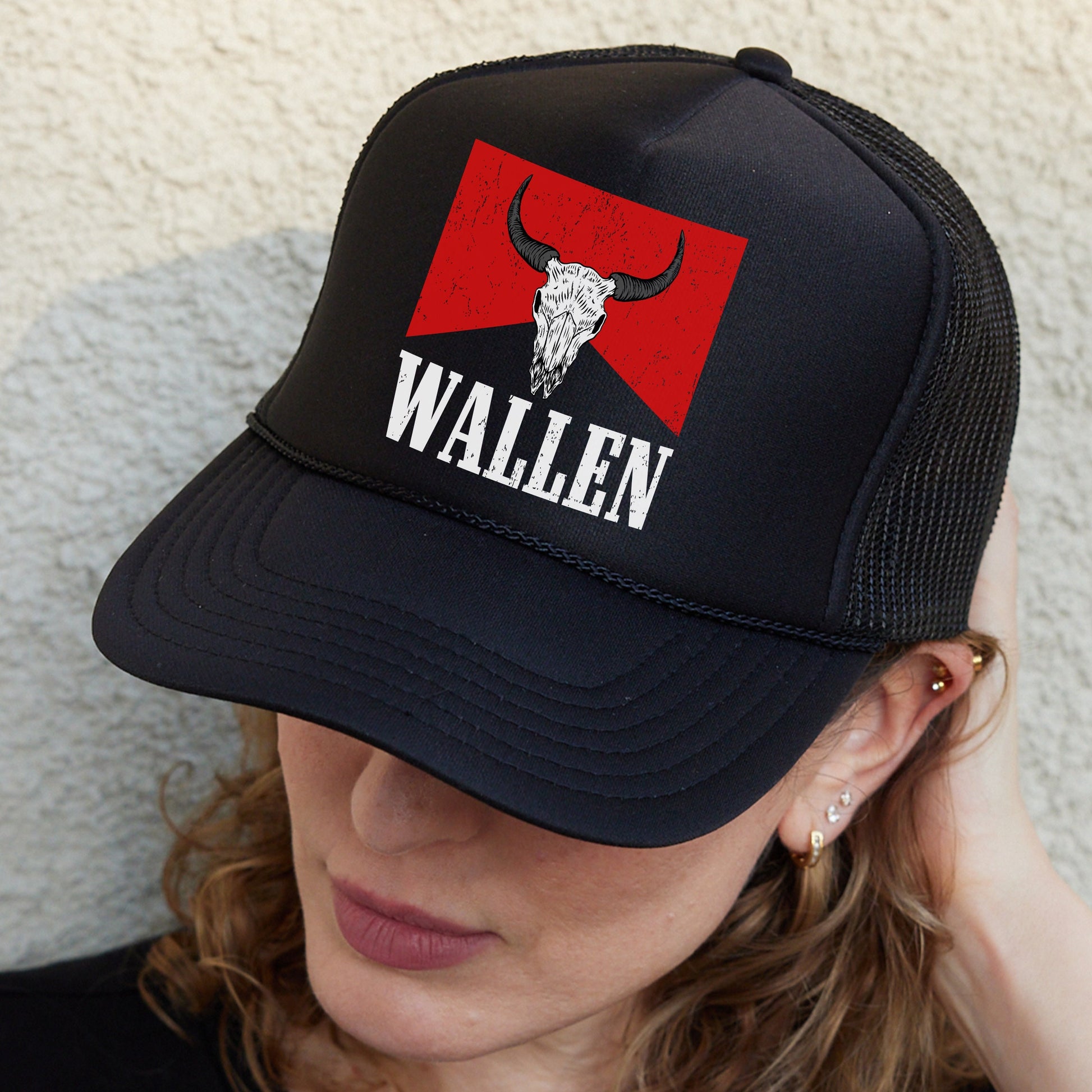 a woman wearing a black hat with a bull&#39;s head on it
