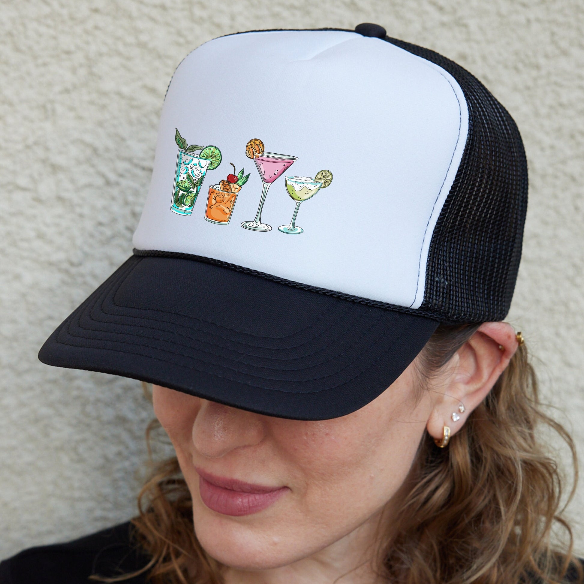 a woman wearing a white and black trucker hat