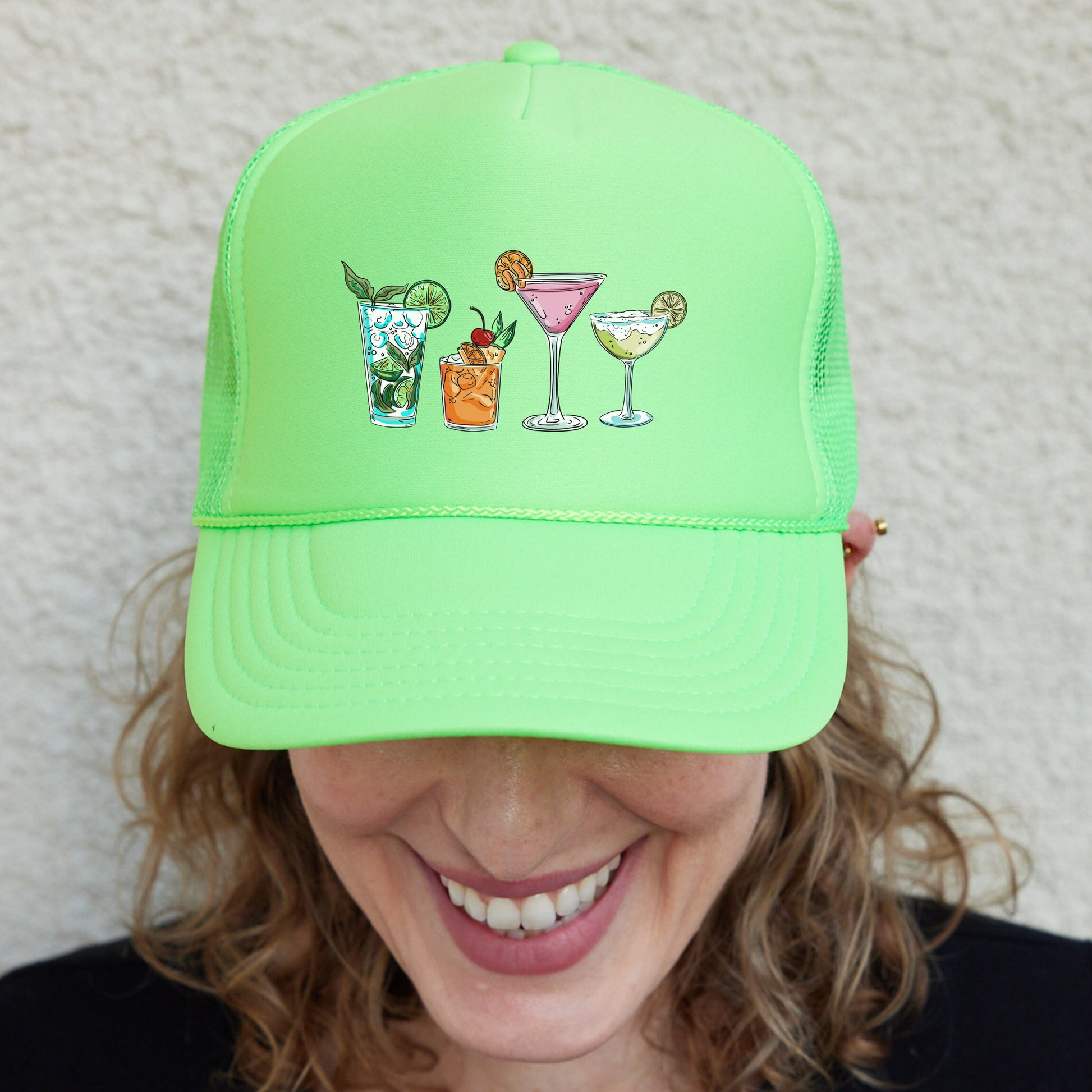 a woman wearing a neon green trucker hat with drinks on it