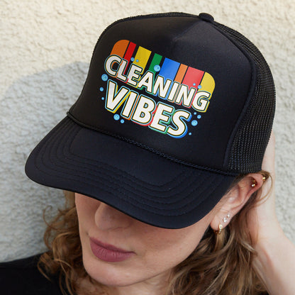 a woman wearing a black cleaning vibes hat