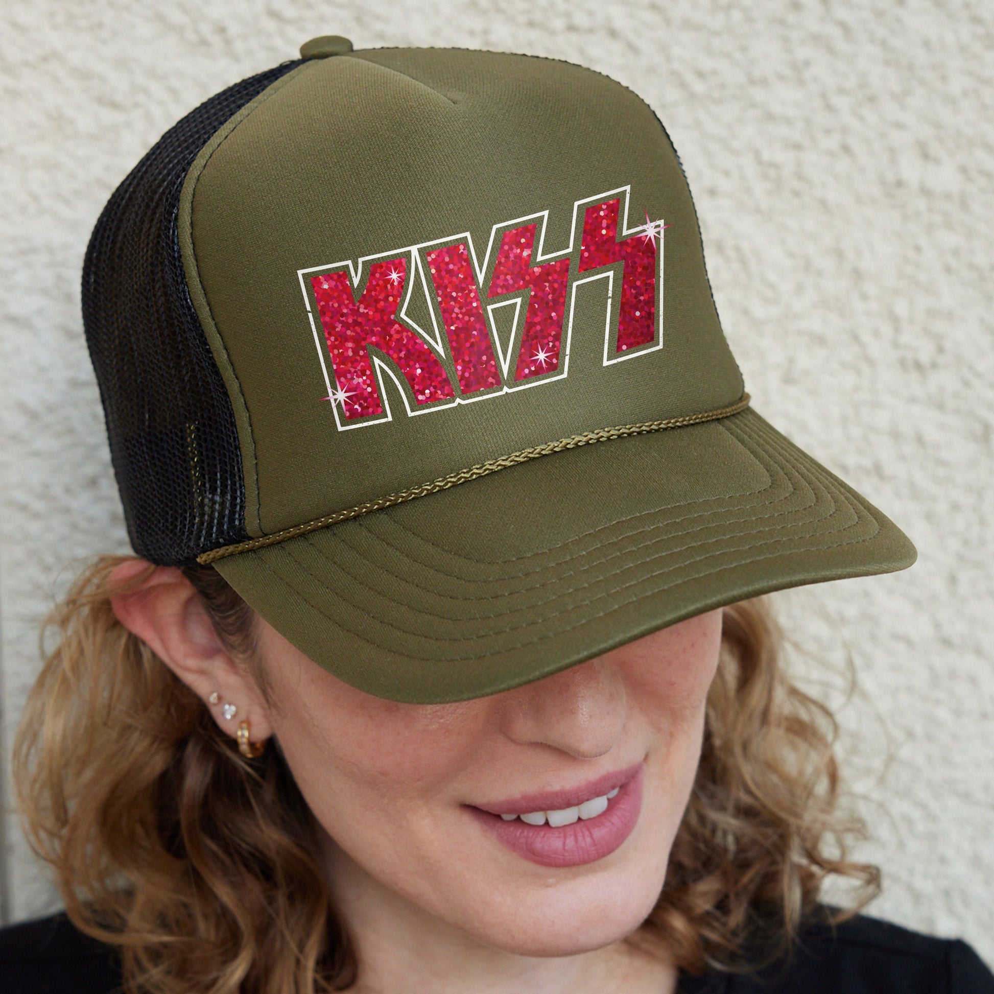 a woman wearing a khaki trucker hat with the word khaki