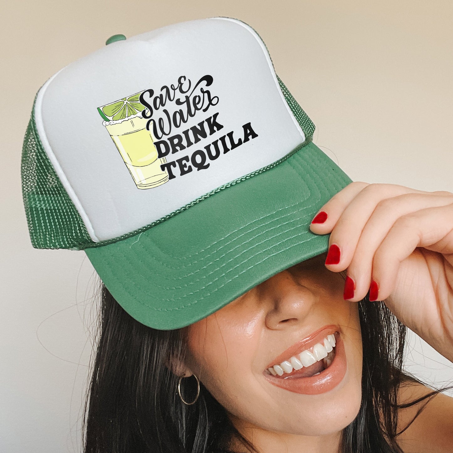 a woman wearing a green and white trucker hat