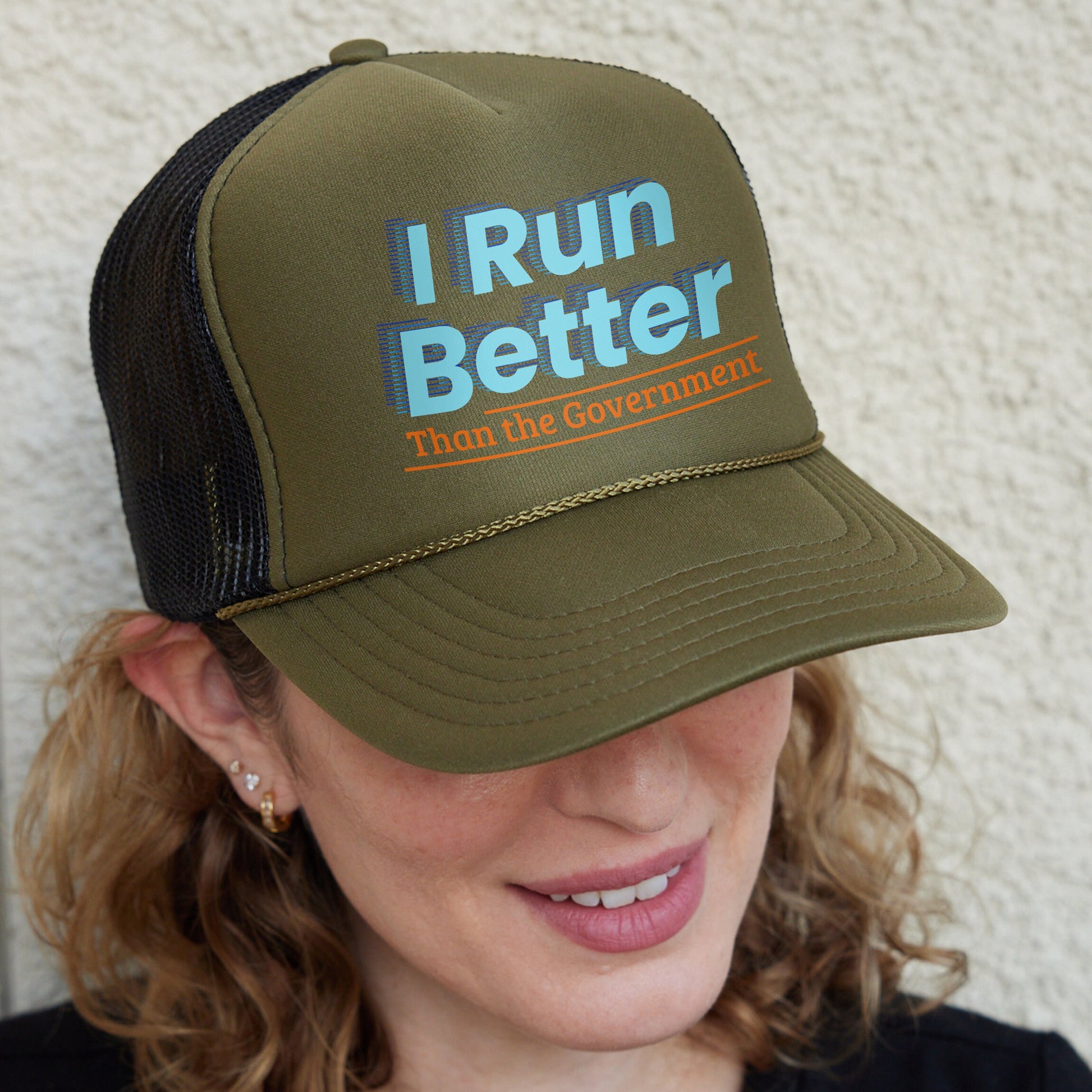 a woman wearing a hat that says i run better than the government