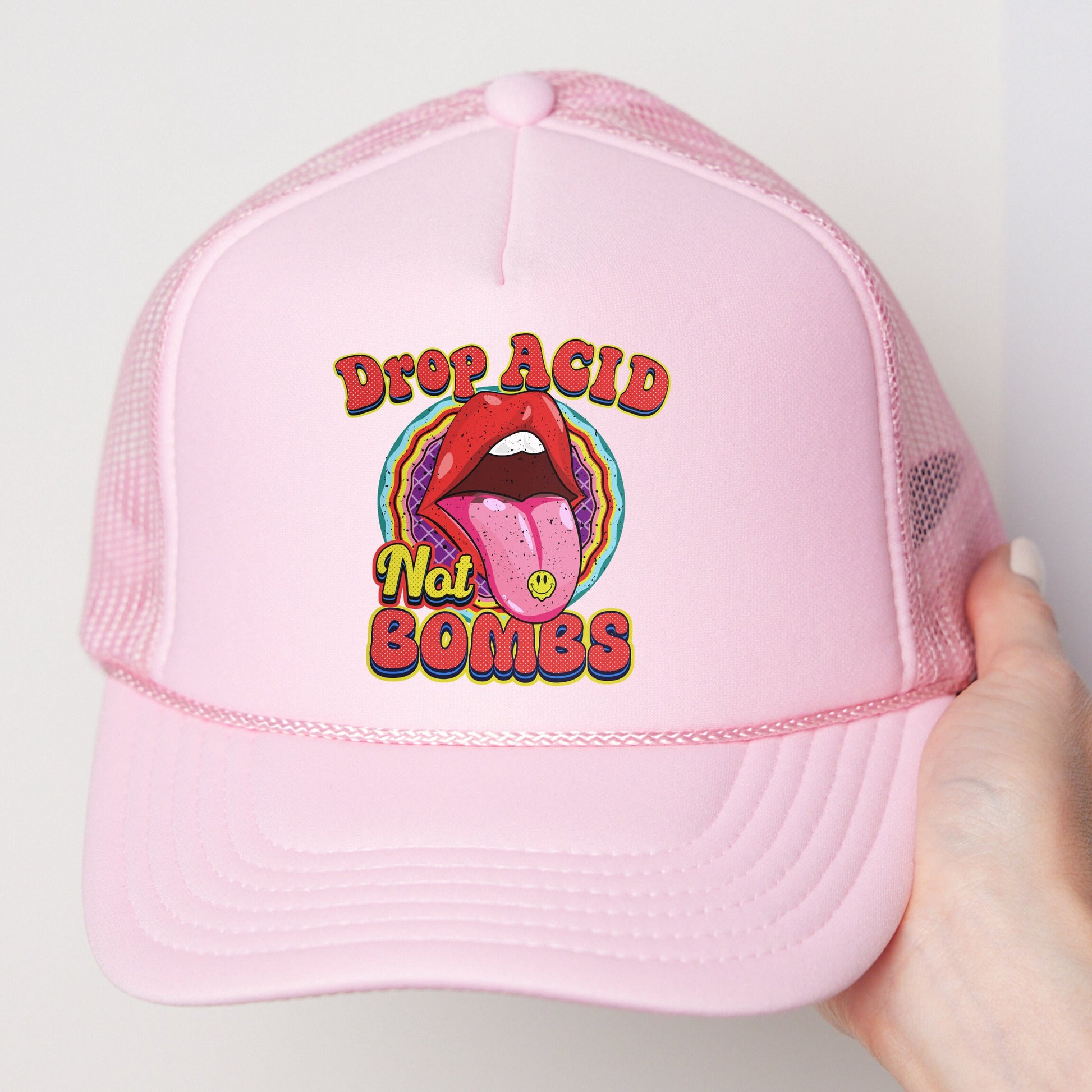 a pink trucker hat with a picture of a tongue sticking out of it