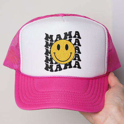 a pink and white trucker hat with a smiley face