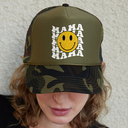 a woman wearing a camo hat with a smiley face on it