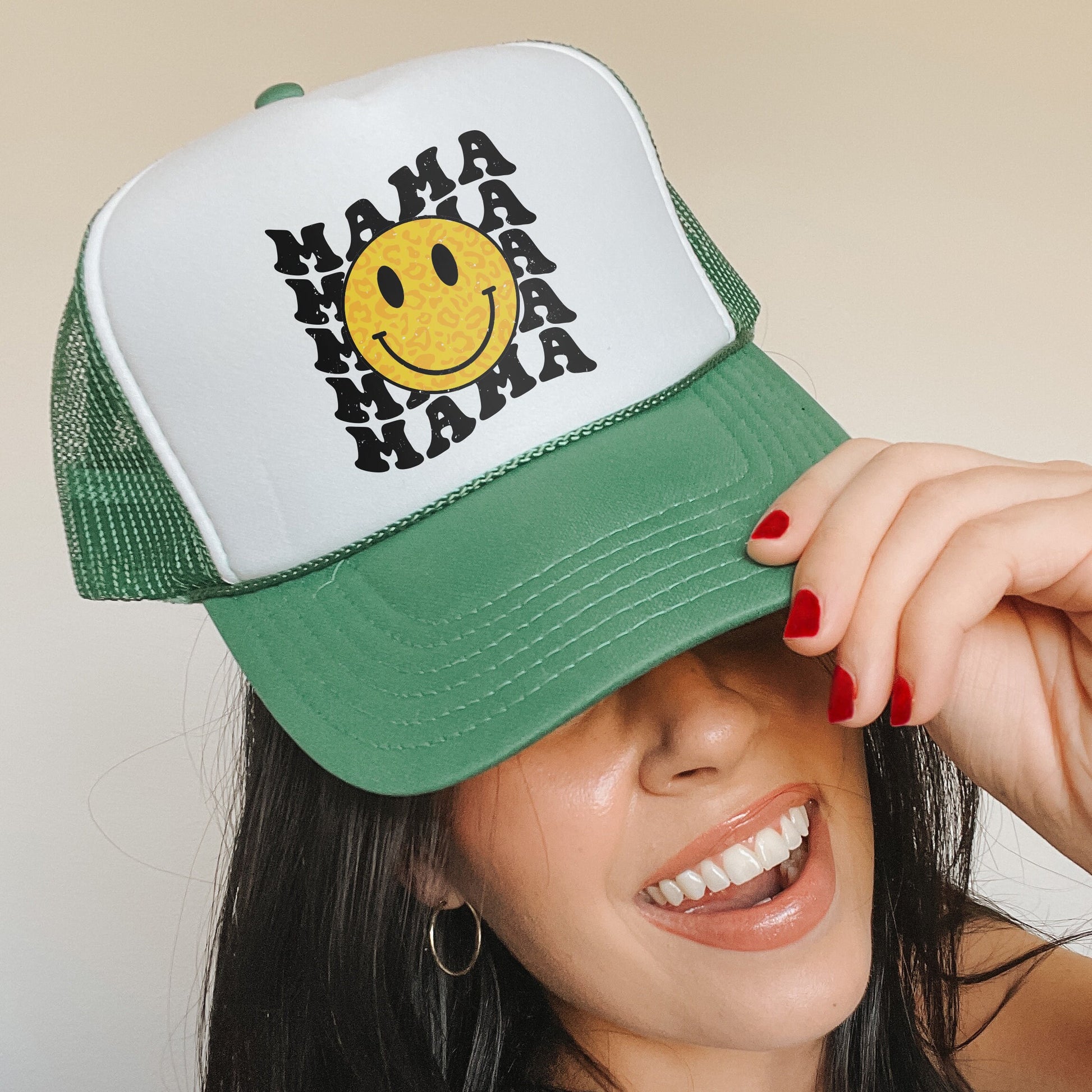 a woman wearing a green and white hat with a smiley face on it