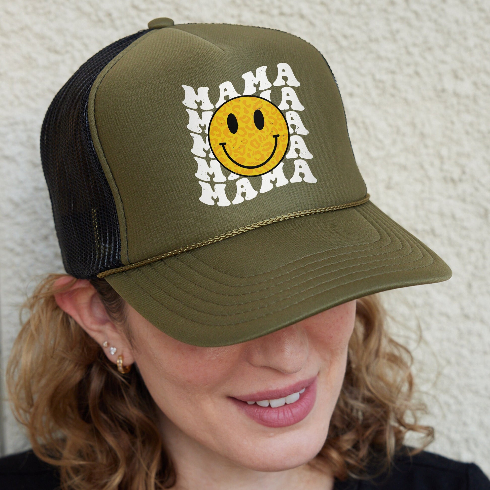 a woman wearing a hat with a smiley face on it