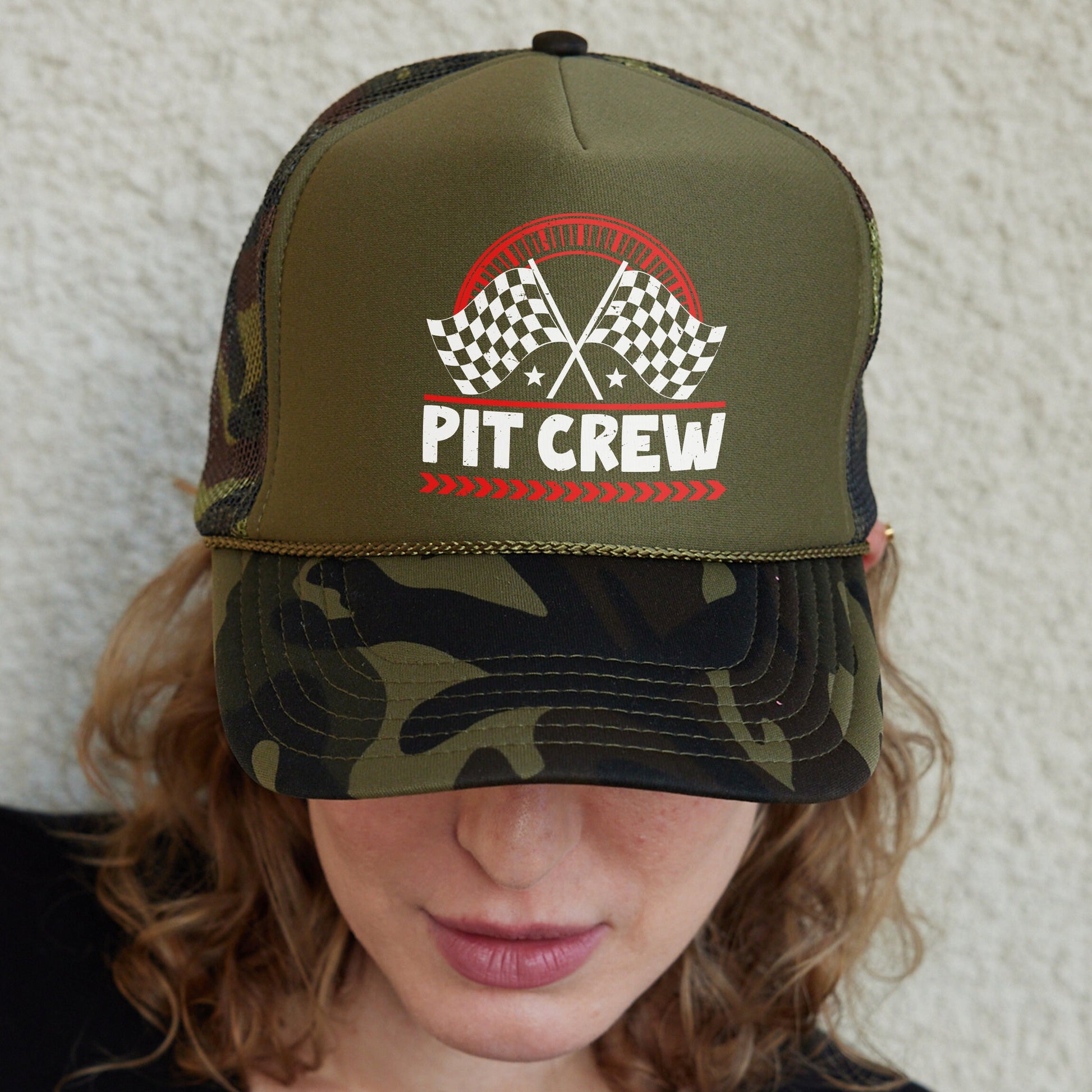 a woman wearing a hat that says pit crew