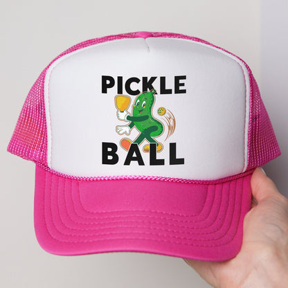 a person holding a pink and white pickle ball hat