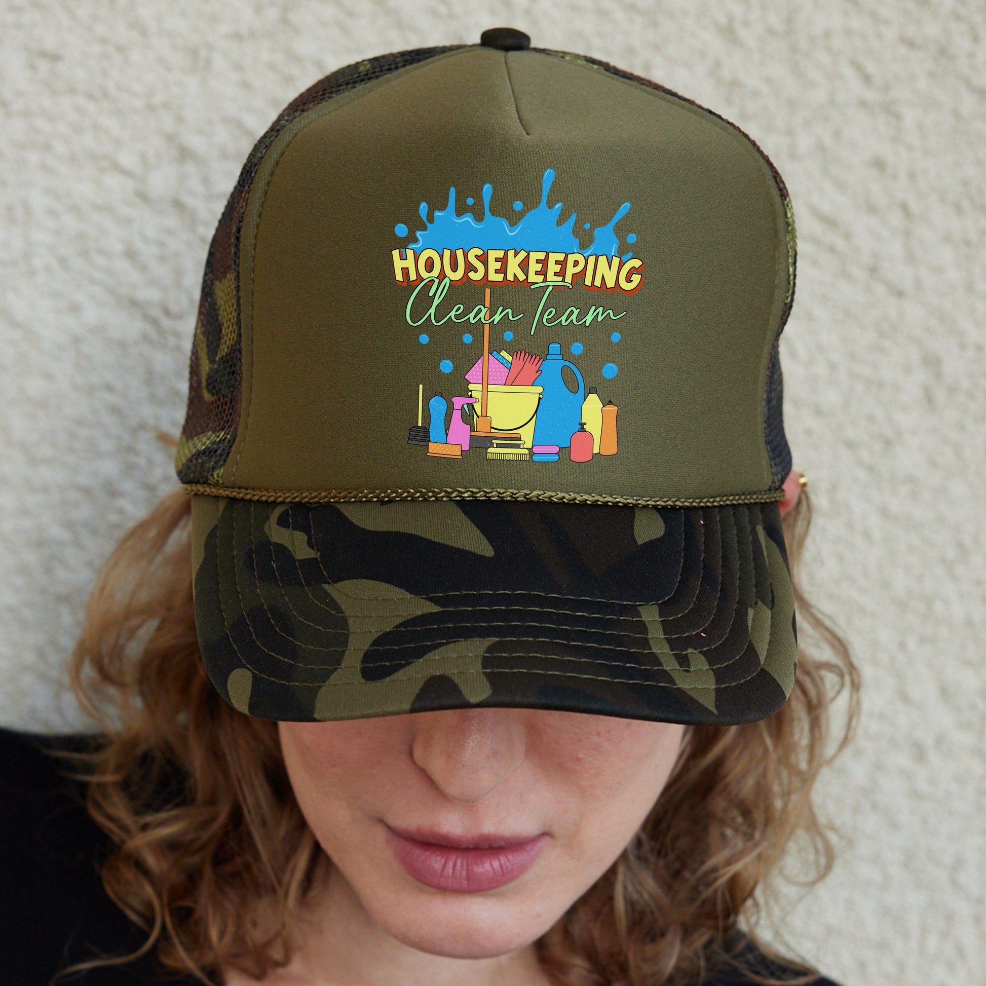 a woman wearing a trucker hat with a house keeping design on it