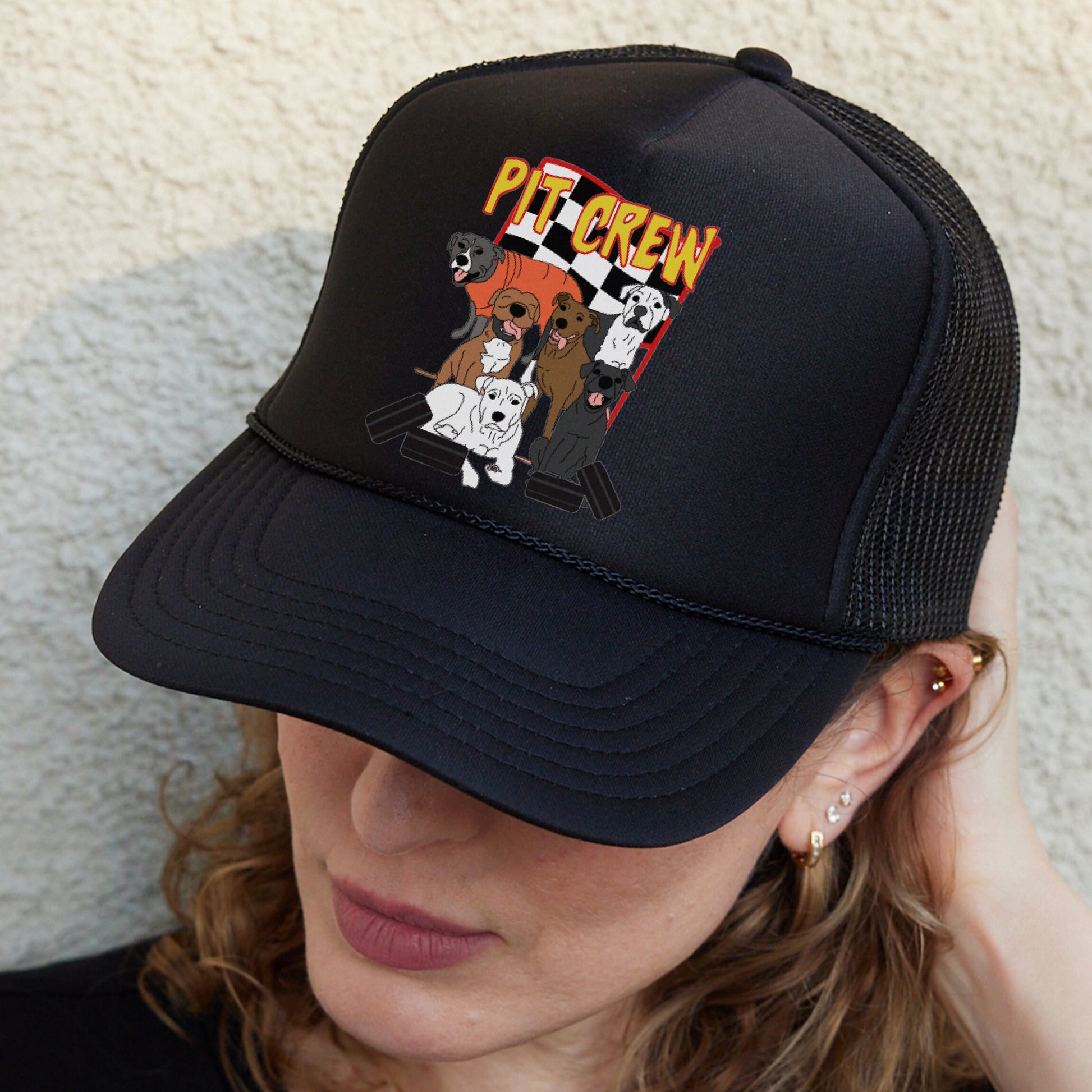 a woman wearing a black hat with dogs on it