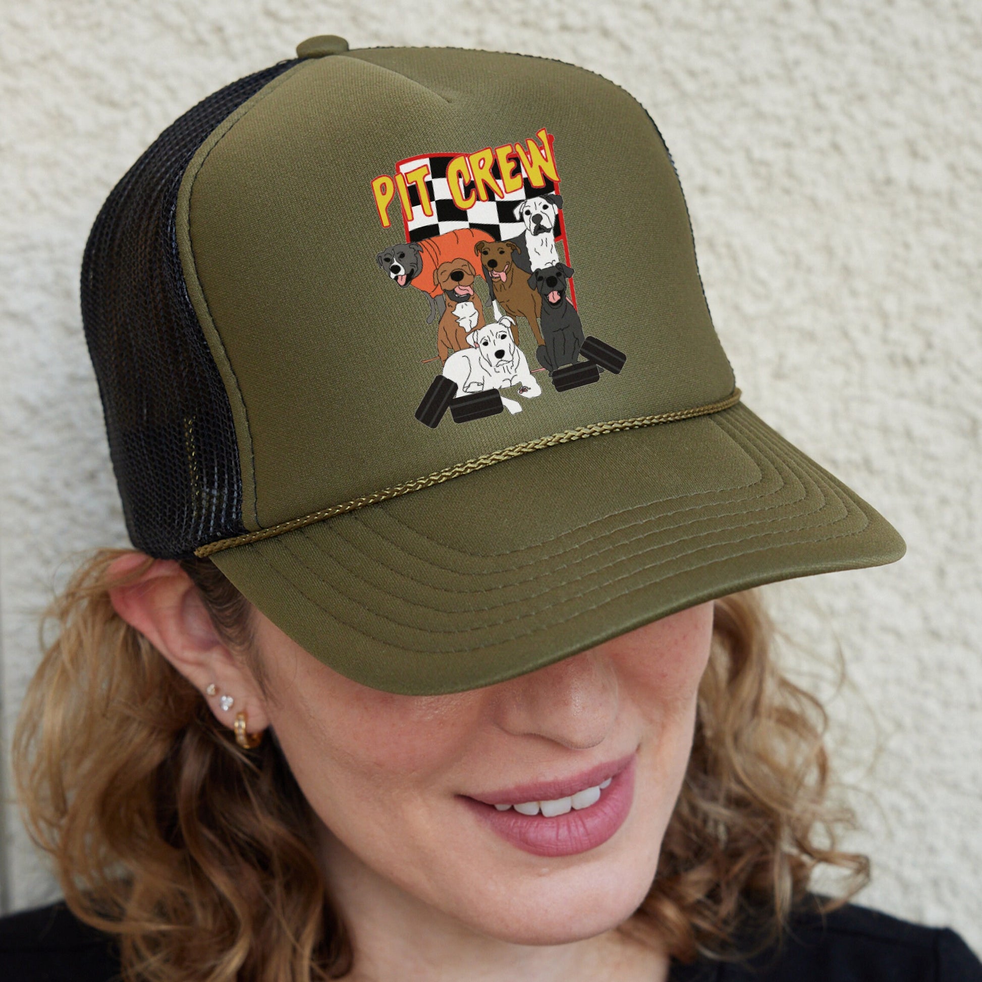 a woman wearing a trucker hat with dogs on it
