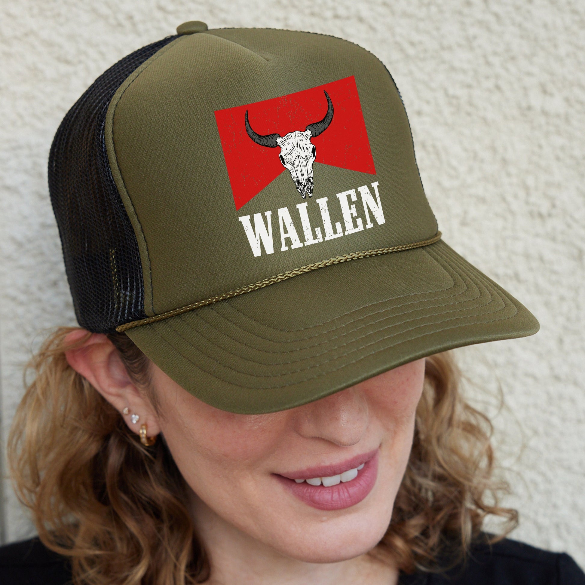 a woman wearing a trucker hat with a bull&#39;s head on it