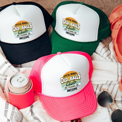 three old balls hats and sunglasses on a towel