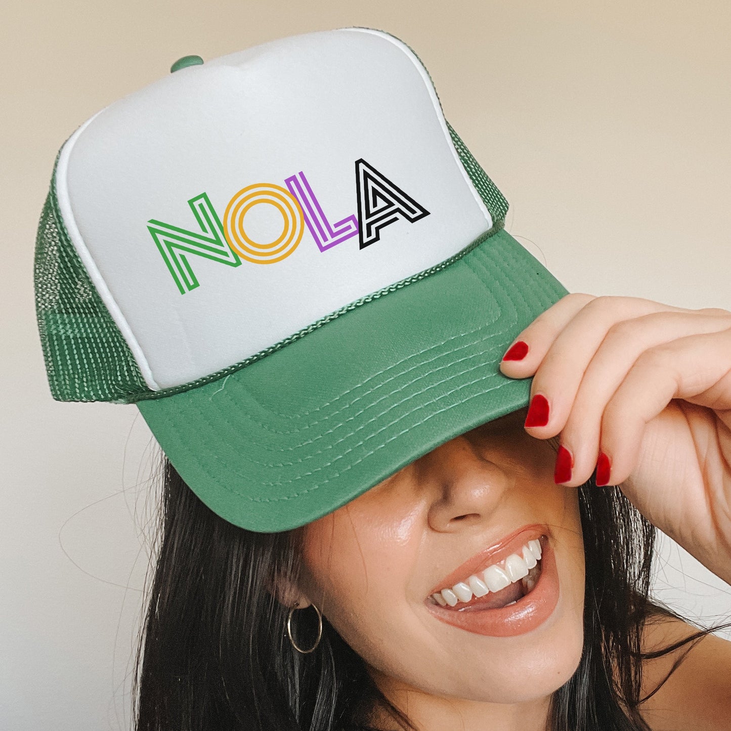 a woman wearing a green and white hat with the word aon on it