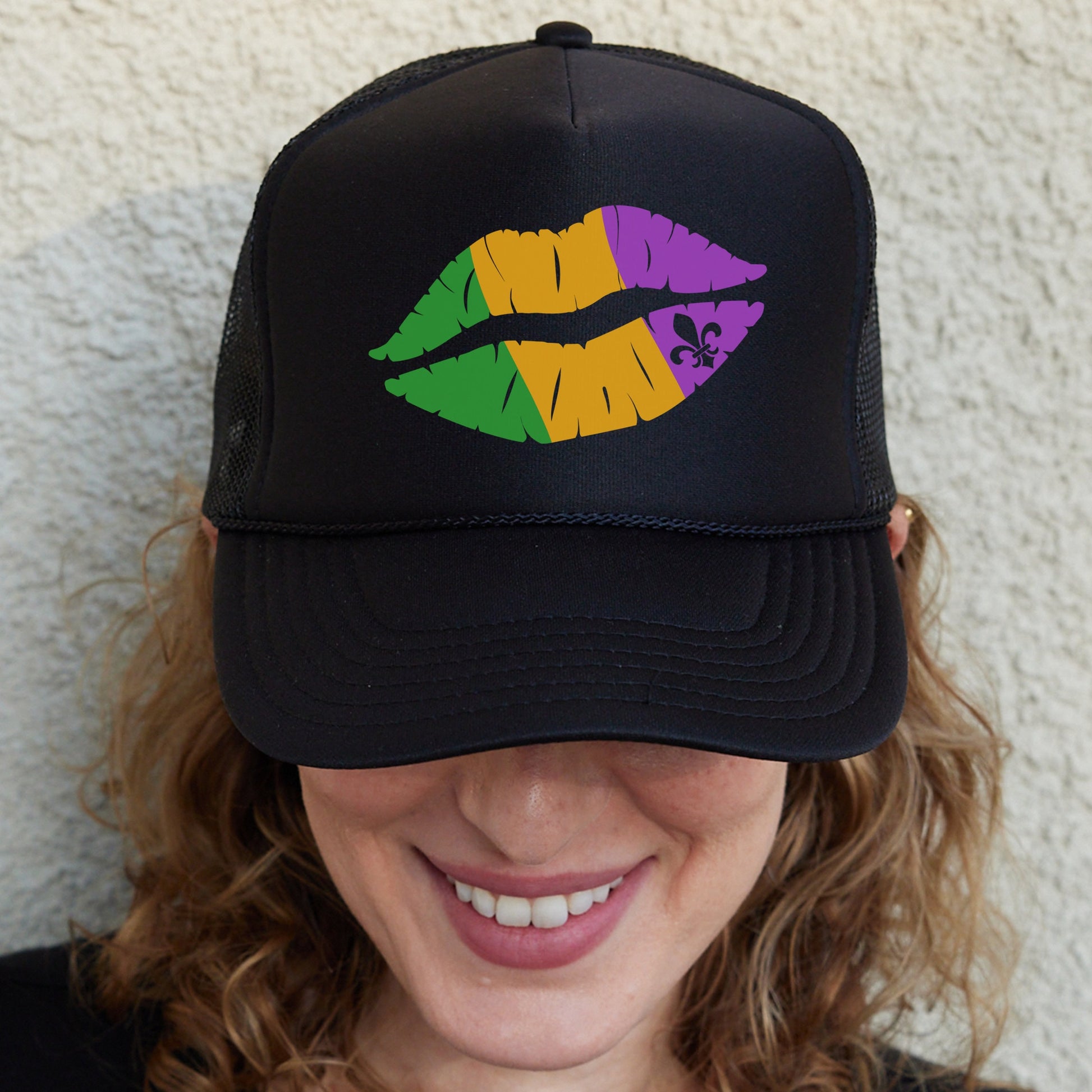 a woman wearing a black hat with colorful lips