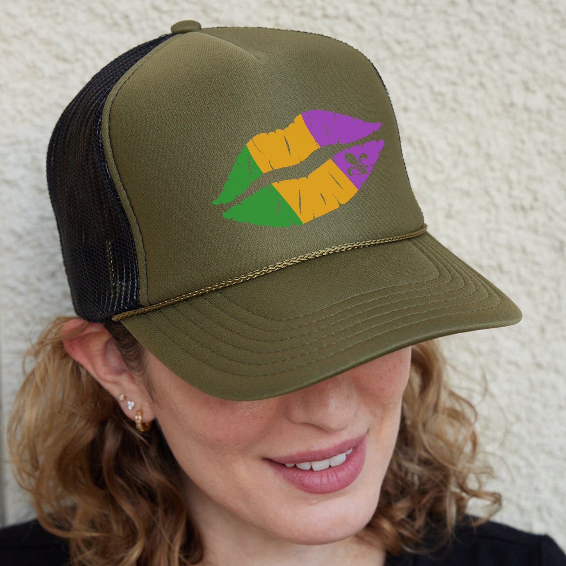 a woman wearing a trucker hat with lipstick painted on it