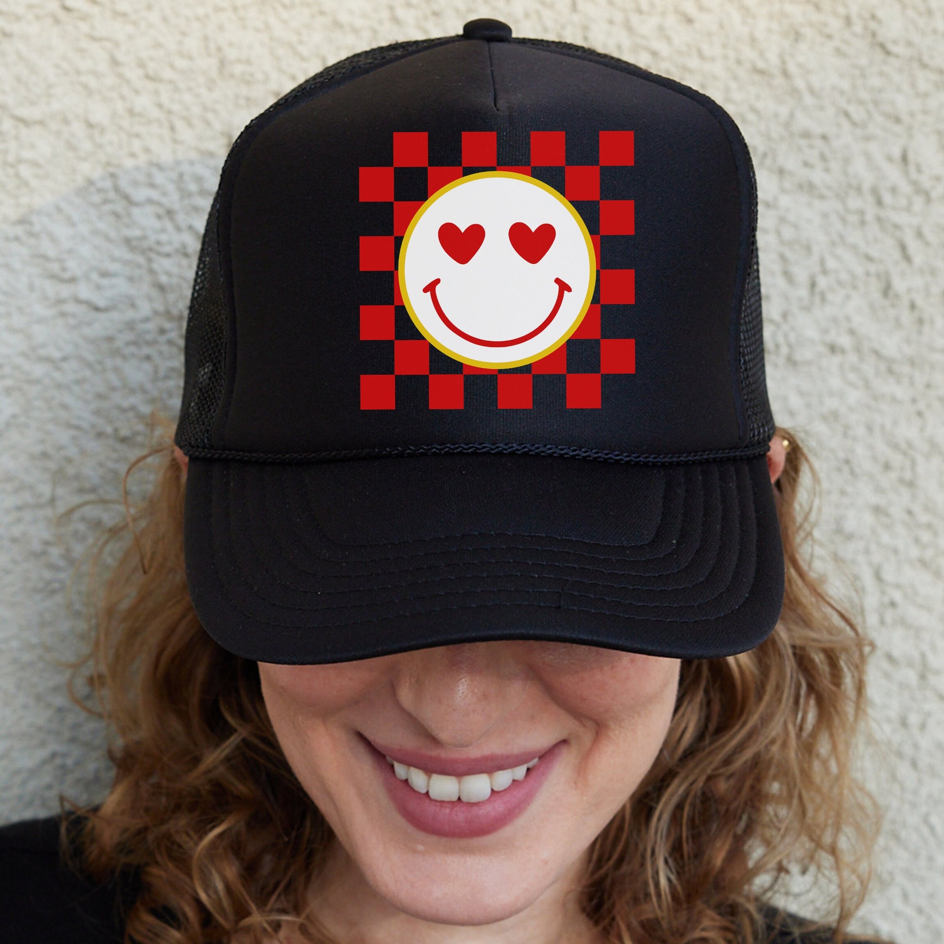 a woman wearing a hat with a smiley face on it