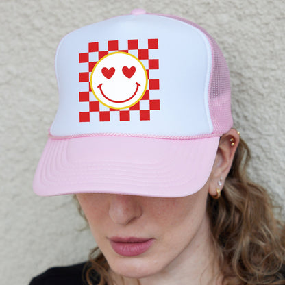 a woman wearing a pink hat with a smiley face on it